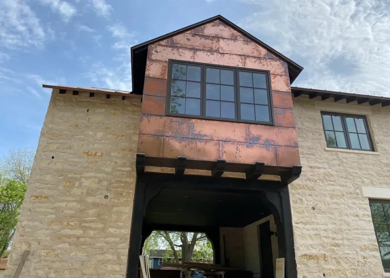 Copper metal panel facade on a stone building for Skylight Installation in La Vergne