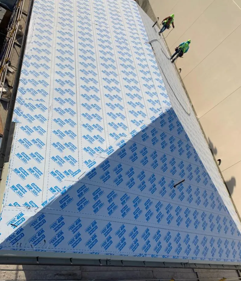 Professional roofers installing underlayment on a metal roof in La Vergne